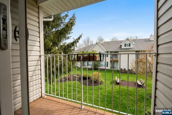 a view of a balcony with yard