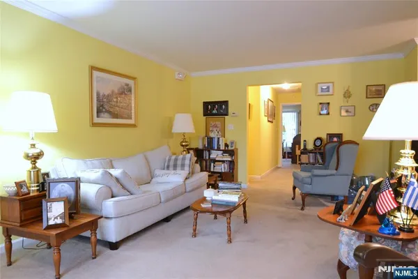a living room with furniture a rug and a lamp