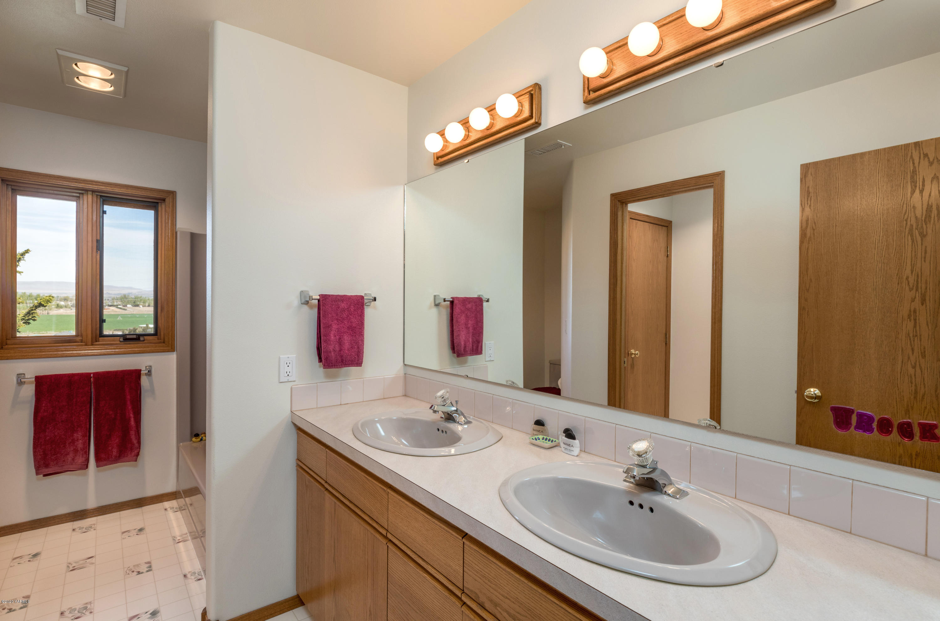 1150 Tear Road Grandview, WA 98930 - Photo 22 of 38 a bathroom with a sink and a mirror
