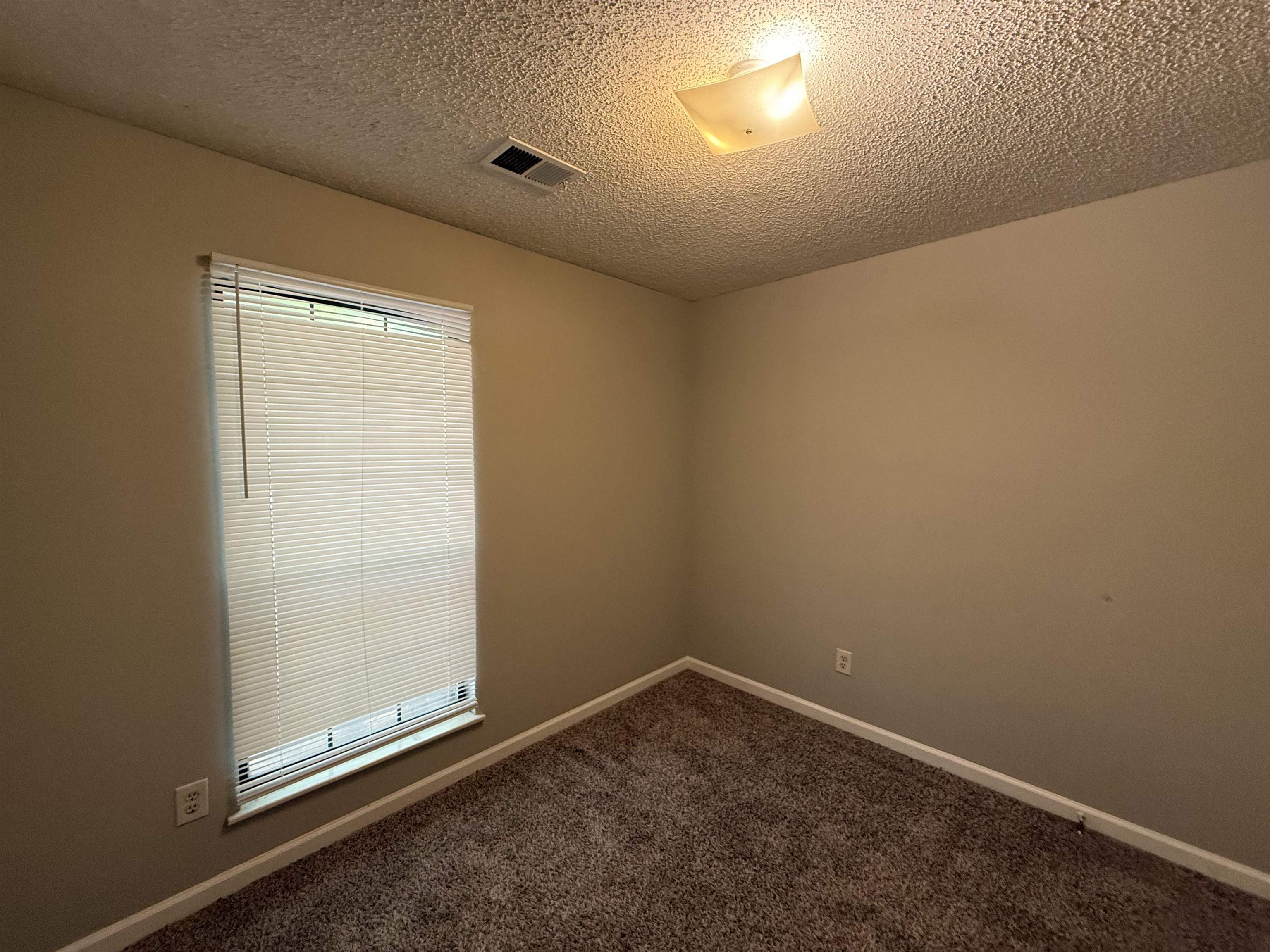 6420 Saginaw Road Memphis, TN 38134 - Photo 18 of 38 Neutral-toned walls complement the textured ceiling