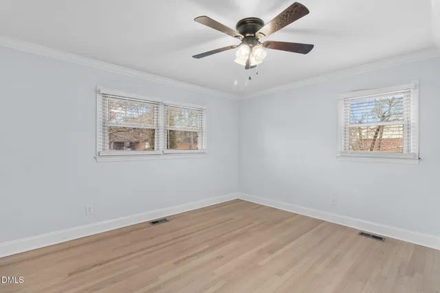 a spacious kitchen with a sink and a refrigerator
