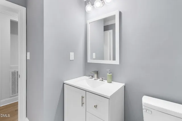 a white toilet sitting next to a bathroom sink
