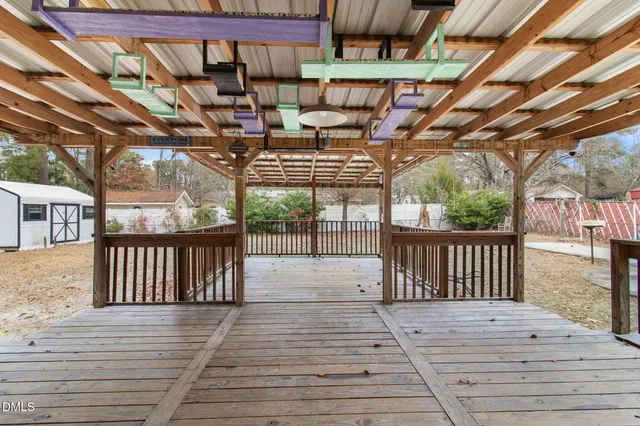 an empty room with wooden floor closet and ceiling fan