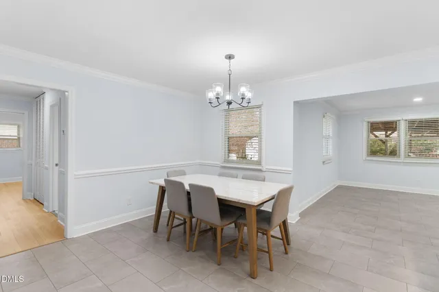 a view of a room with a ceiling fan and wooden floor