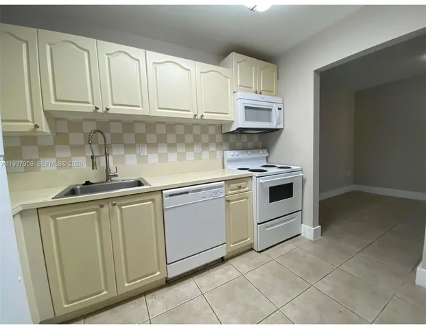 a kitchen with stainless steel appliances granite countertop a sink and cabinets