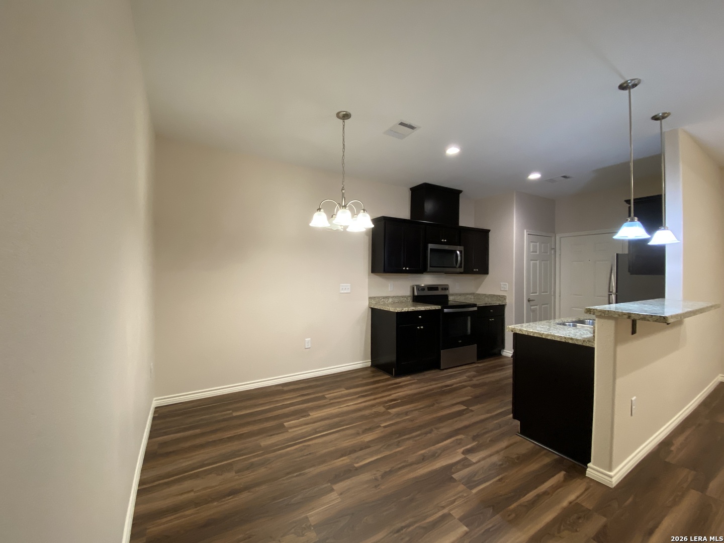 629 Commerce Street Pleasanton, TX 78064 - Photo 2 of 11 a kitchen with a sink and a stove top oven