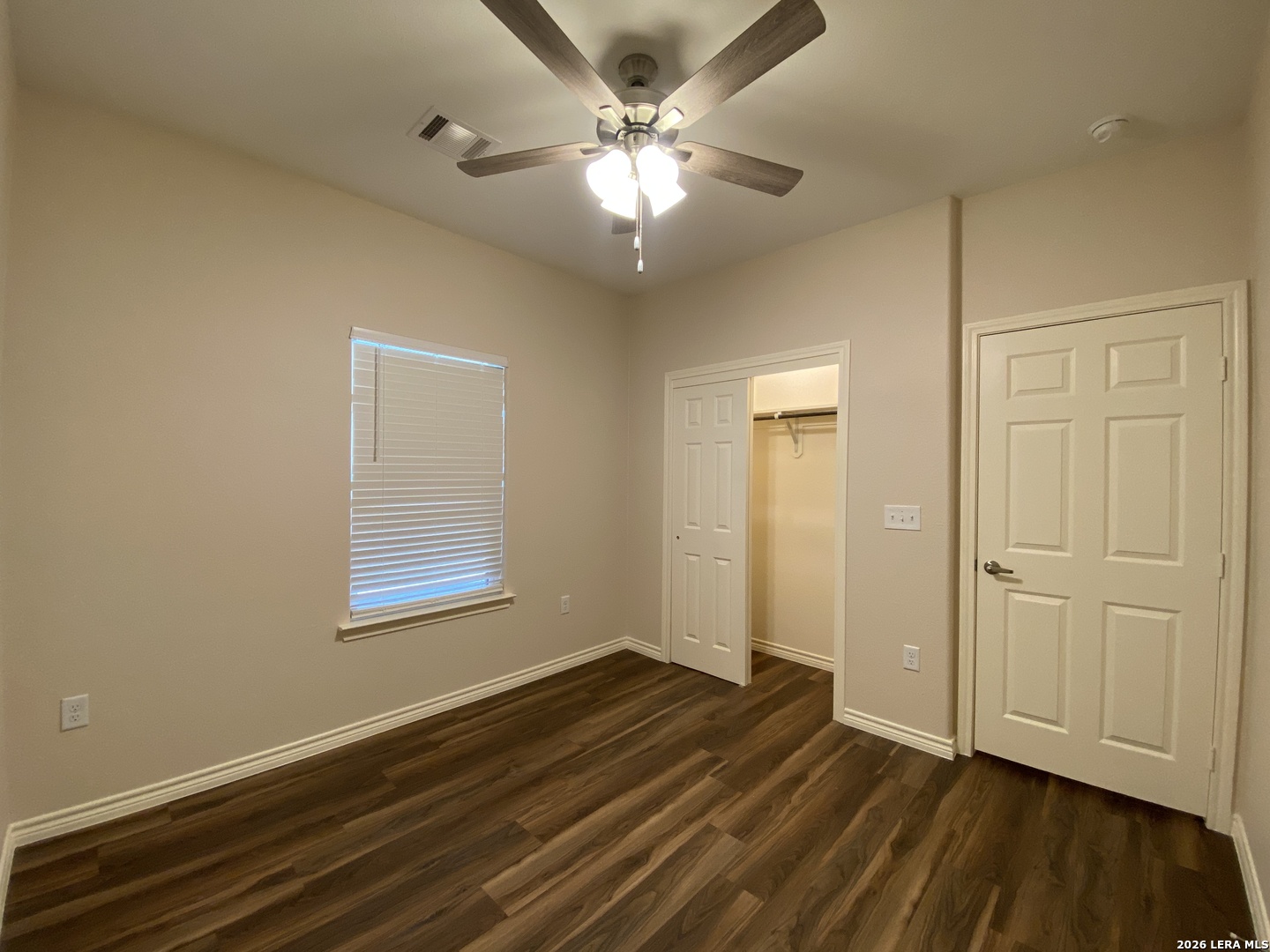 629 Commerce Street Pleasanton, TX 78064 - Photo 9 of 11 an empty room with wooden floor and windows