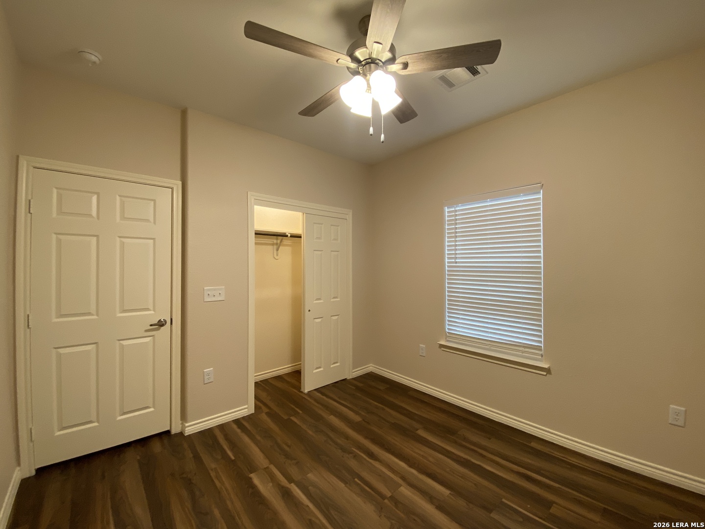 629 Commerce Street Pleasanton, TX 78064 - Photo 10 of 11 wooden floor in an empty room with a window