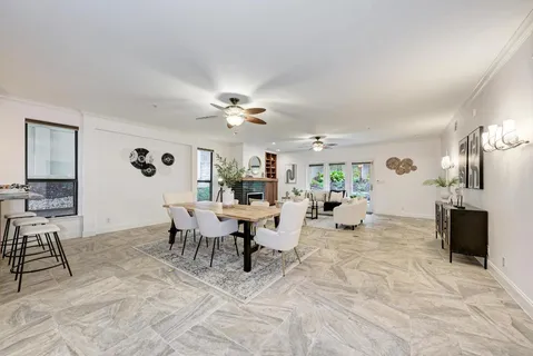 a living room with furniture a fireplace and a chandelier