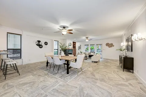 a living room with furniture a fireplace and a chandelier