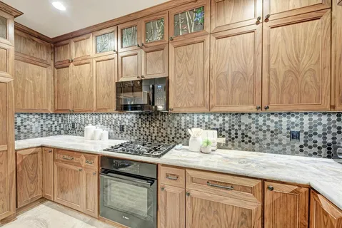 a kitchen with kitchen island granite countertop a table and chairs in it