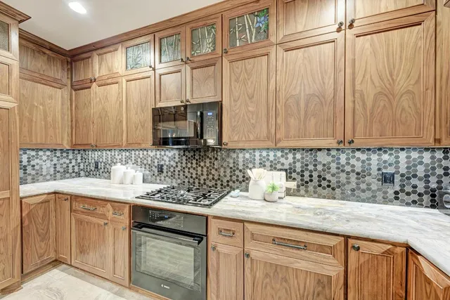 a kitchen with kitchen island granite countertop a table and chairs in it
