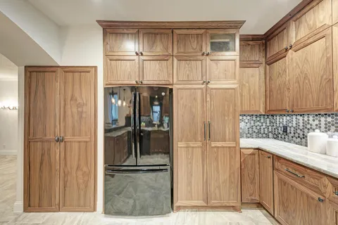 a kitchen with stainless steel appliances kitchen island granite countertop a stove and cabinets