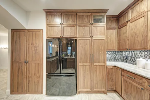 a kitchen with stainless steel appliances kitchen island granite countertop a stove and cabinets