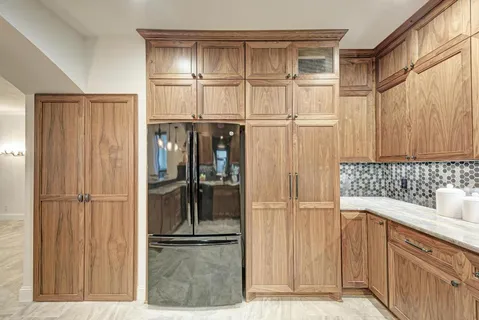 a kitchen with stainless steel appliances kitchen island granite countertop a stove and cabinets