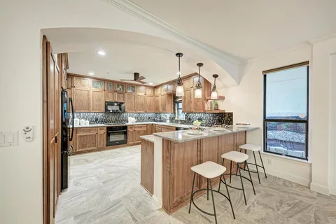 a living room with furniture and view of kitchen