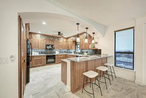a living room with furniture and view of kitchen