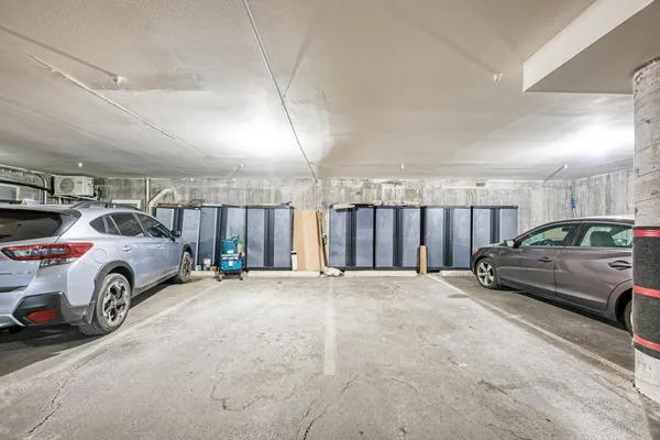 a backyard with potted plants and a wooden bench