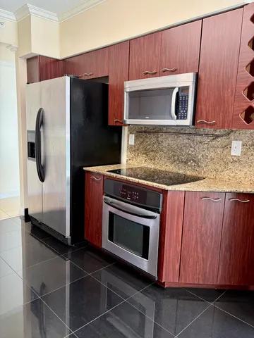 a bedroom with a bed and a flat tv screen next to a window