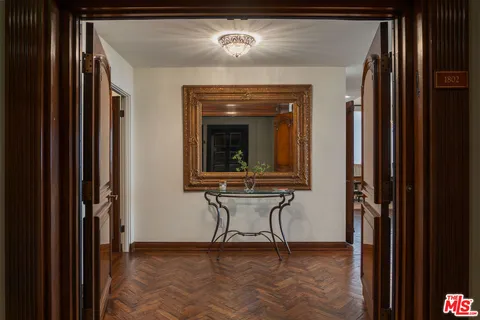 a view of a hallway with a door and a mirror