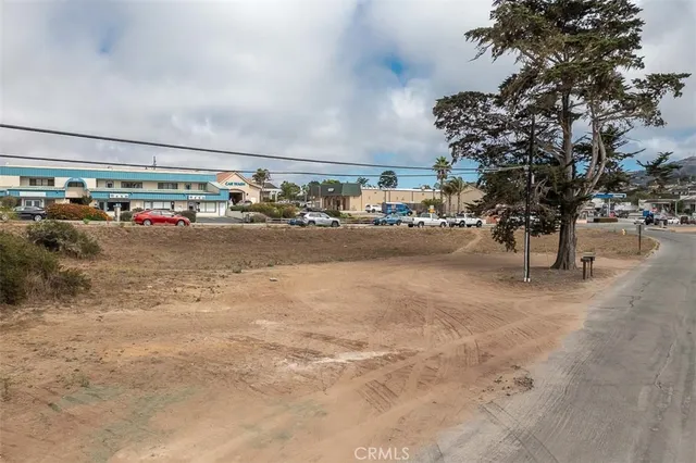 a street sign on a sidewalk next to a road