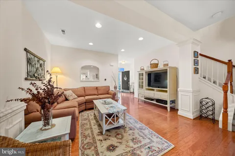 a living room with fireplace furniture and a wooden floor