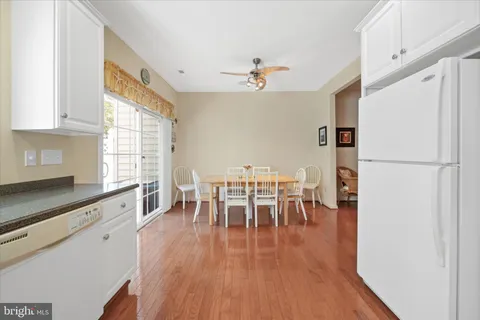 a view of a dining room with furniture a chandelier and wooden floor