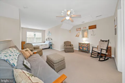 a living room with furniture a couch and a chandelier