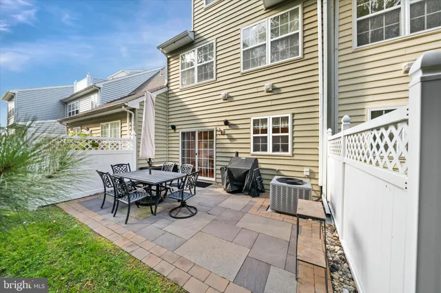 a view of a patio with table and chairs and potted plants