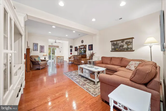 a living room with furniture wooden floor and a table