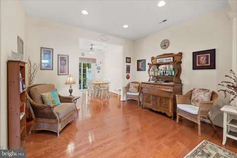a living room with furniture wooden floor and a table