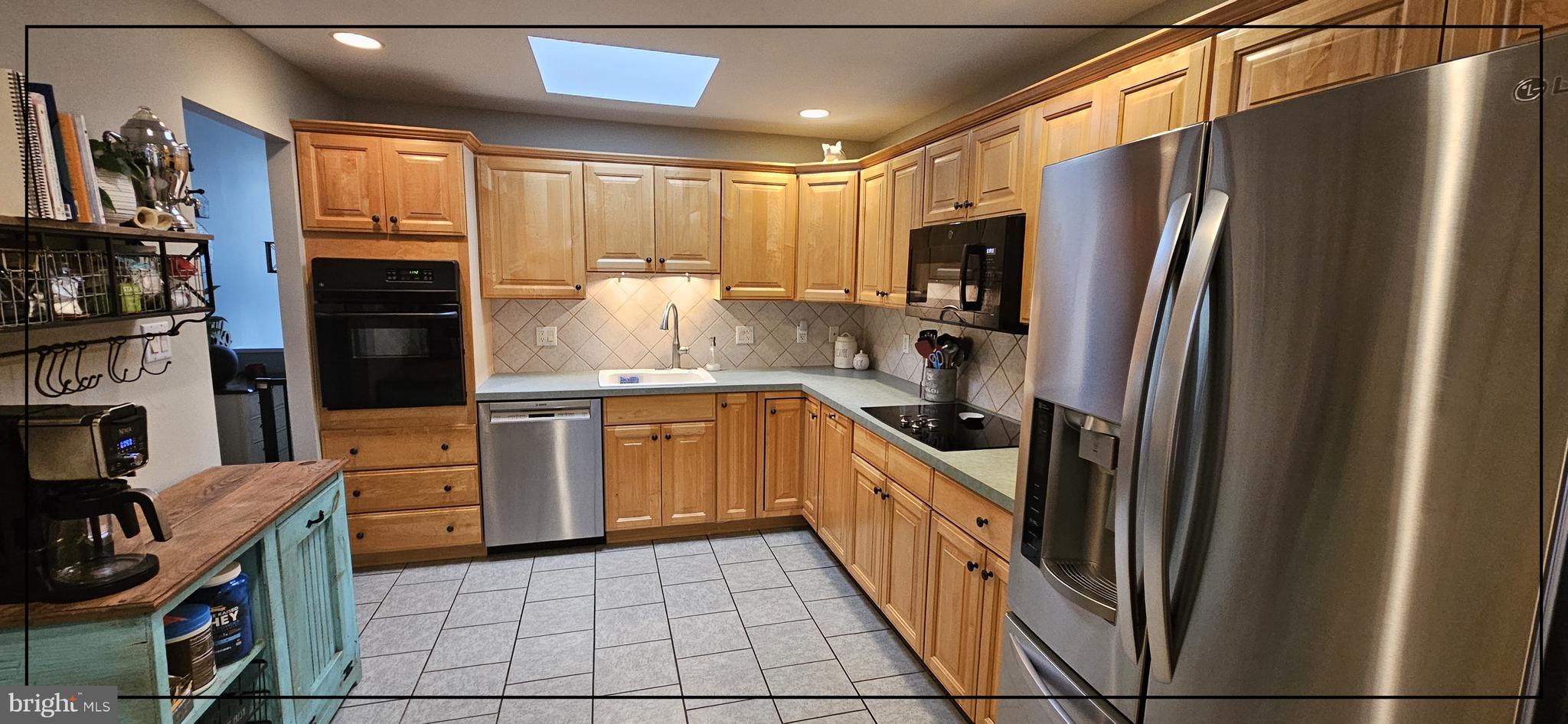 1109 Grinnell Road Wilmington, DE 19803 - Photo 5 of 29 a kitchen with stainless steel appliances granite countertop a refrigerator stove and sink
