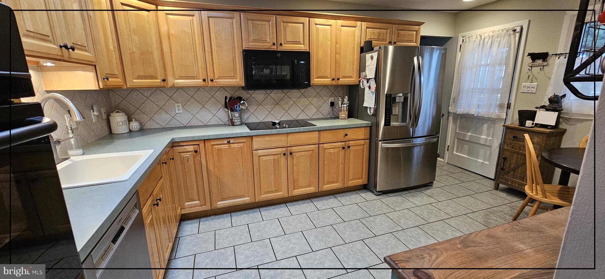 1109 Grinnell Road Wilmington, DE 19803 - Photo 6 of 29 a kitchen with stainless steel appliances granite countertop a refrigerator and a sink