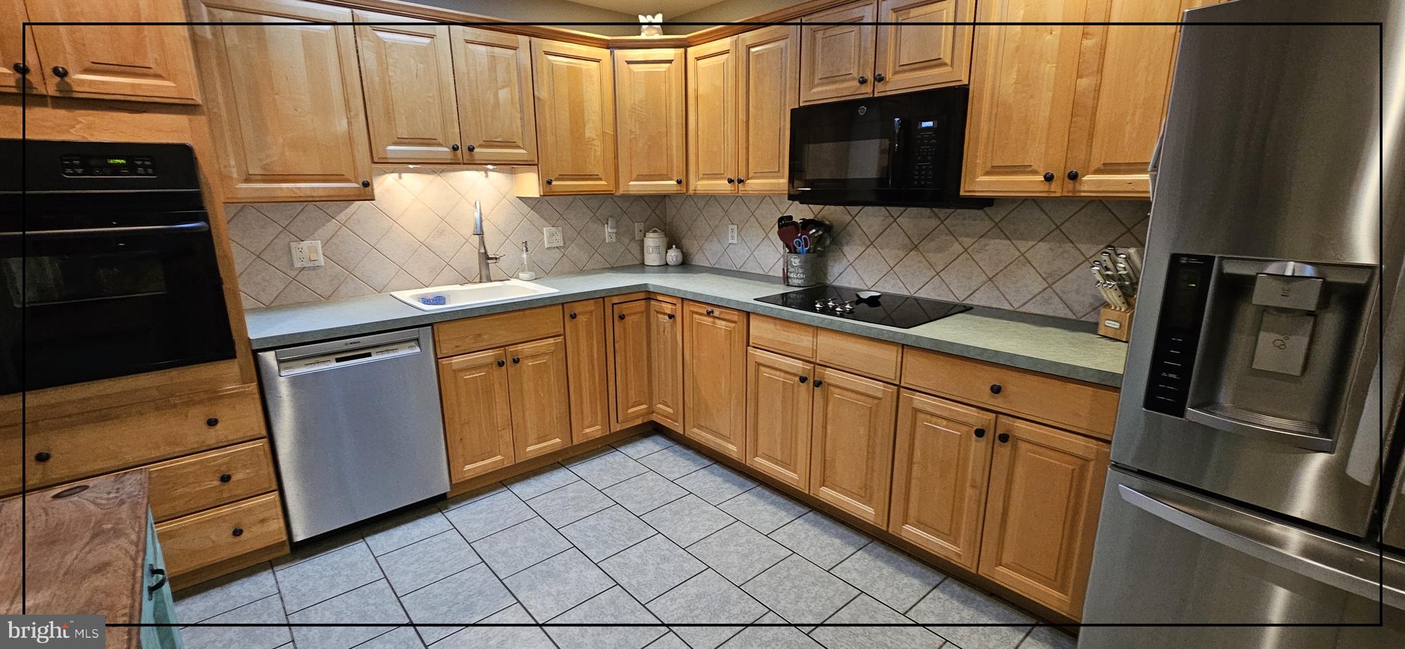 1109 Grinnell Road Wilmington, DE 19803 - Photo 8 of 29 a kitchen with granite countertop a refrigerator stove and sink