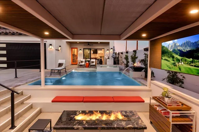 a living room with furniture a flat screen tv and a fireplace