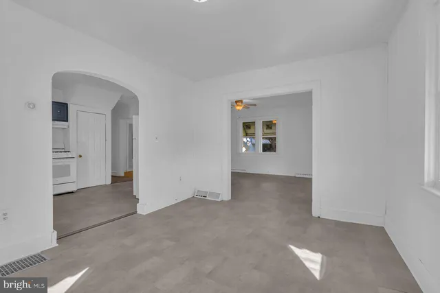 a kitchen with a stove sink and cabinets