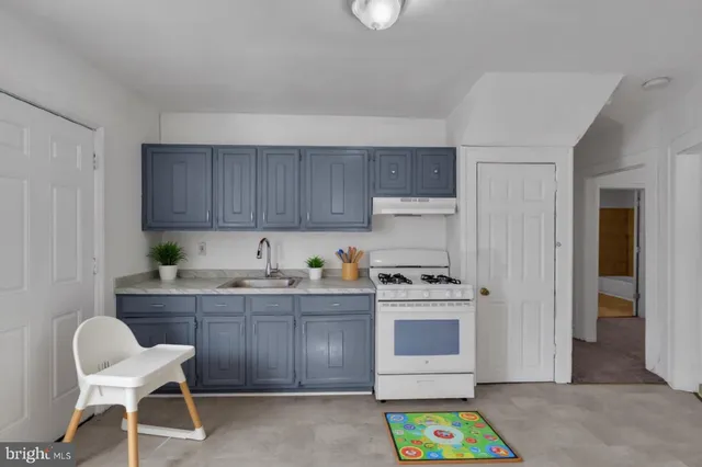 a kitchen with granite countertop a sink stainless steel appliances and cabinets