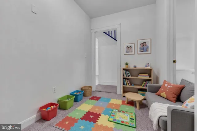 a bathroom with a white tub a potted plant and a window