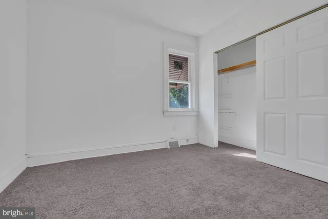 a yellow and red sign sitting on the side of a street