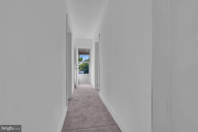 a view of empty room with wooden walls