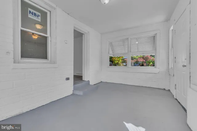 an empty room with windows and way