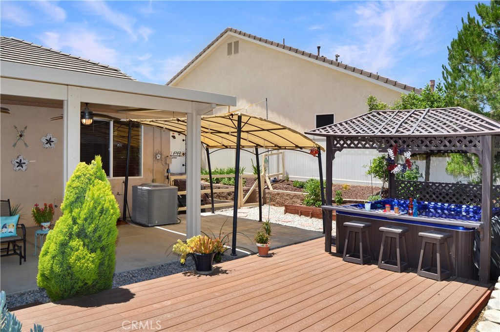 166 Fox Lane Calimesa, CA 92320 - Photo 73 of 76 Deck, spa, patio, garden beds, and access to the RV parking area