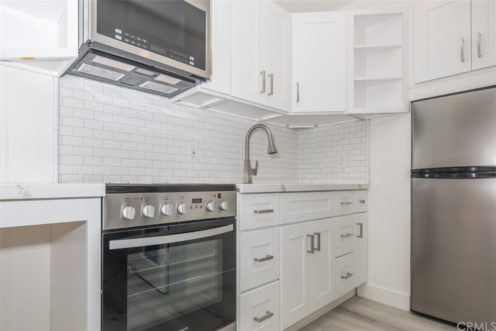 319 Cypress Drive, Unit B Laguna Beach, CA 92651 - Photo 11 of 39 a stove top oven sitting inside of a kitchen