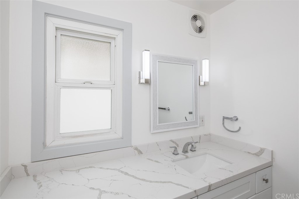 319 Cypress Drive, Unit B Laguna Beach, CA 92651 - Photo 14 of 39 a bathroom with a sink and a mirror