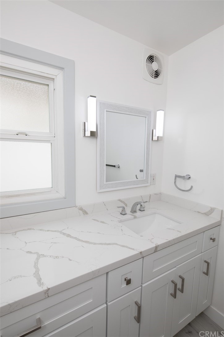 319 Cypress Drive, Unit B Laguna Beach, CA 92651 - Photo 15 of 39 a bathroom with a sink and a mirror