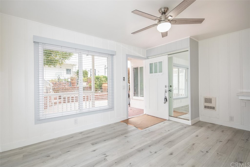 319 Cypress Drive, Unit B Laguna Beach, CA 92651 - Photo 4 of 39 a view of an empty room with wooden floor and a window