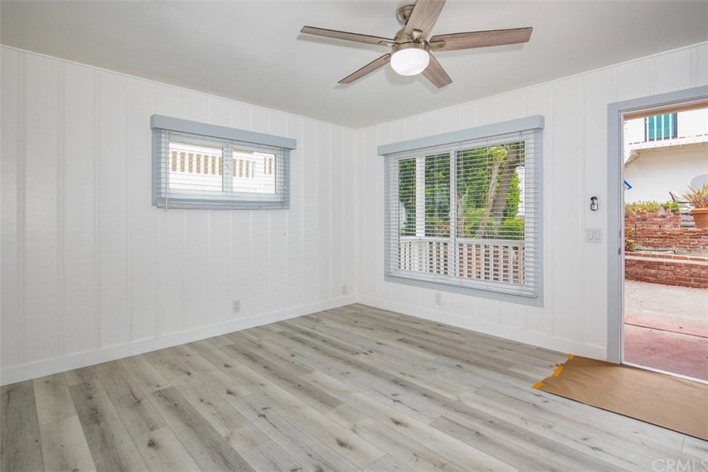 319 Cypress Drive, Unit B Laguna Beach, CA 92651 - Photo 5 of 39 a view of an empty room with wooden floor and a window
