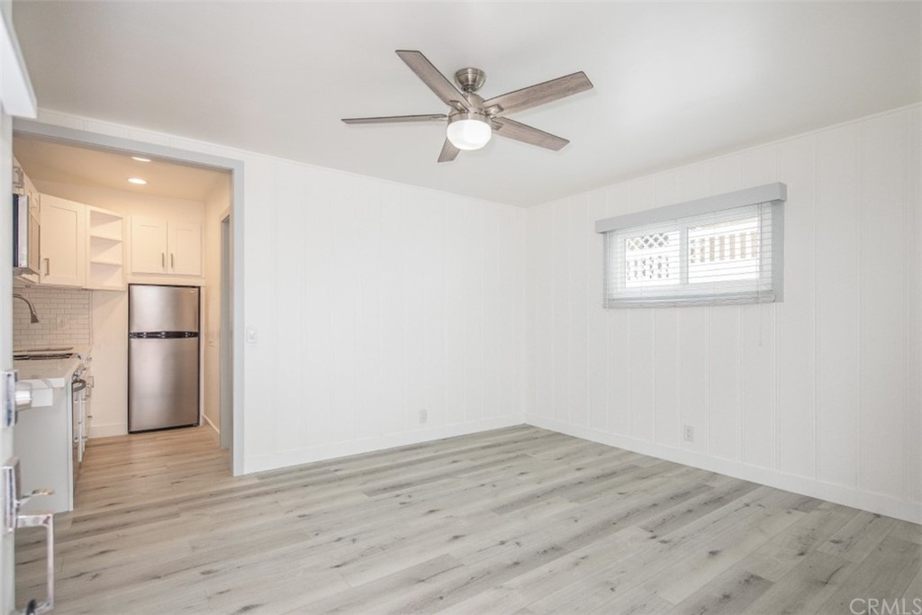 319 Cypress Drive, Unit B Laguna Beach, CA 92651 - Photo 7 of 39 a view of a livingroom with wooden floor and a ceiling fan