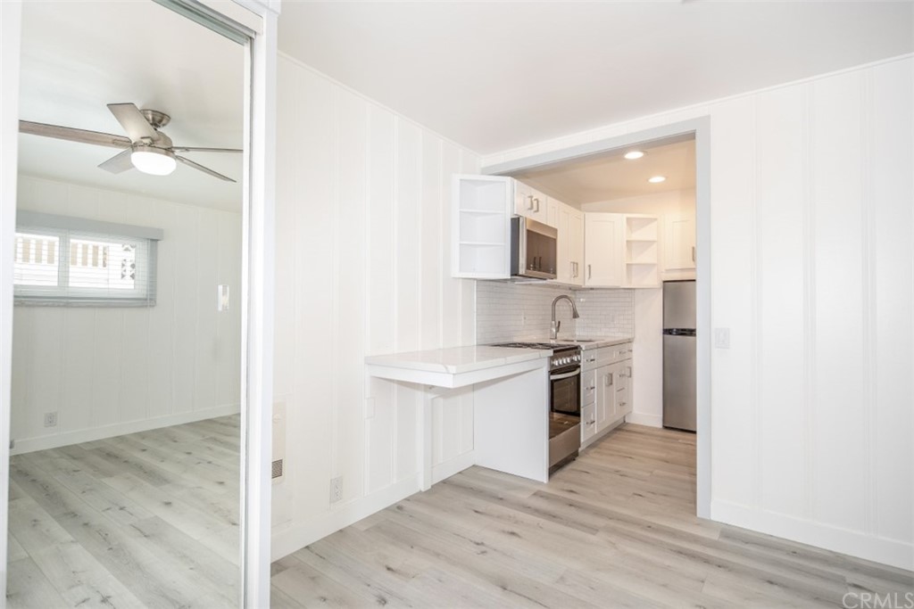 319 Cypress Drive, Unit B Laguna Beach, CA 92651 - Photo 8 of 39 a kitchen with stainless steel appliances granite countertop a stove a sink and a refrigerator