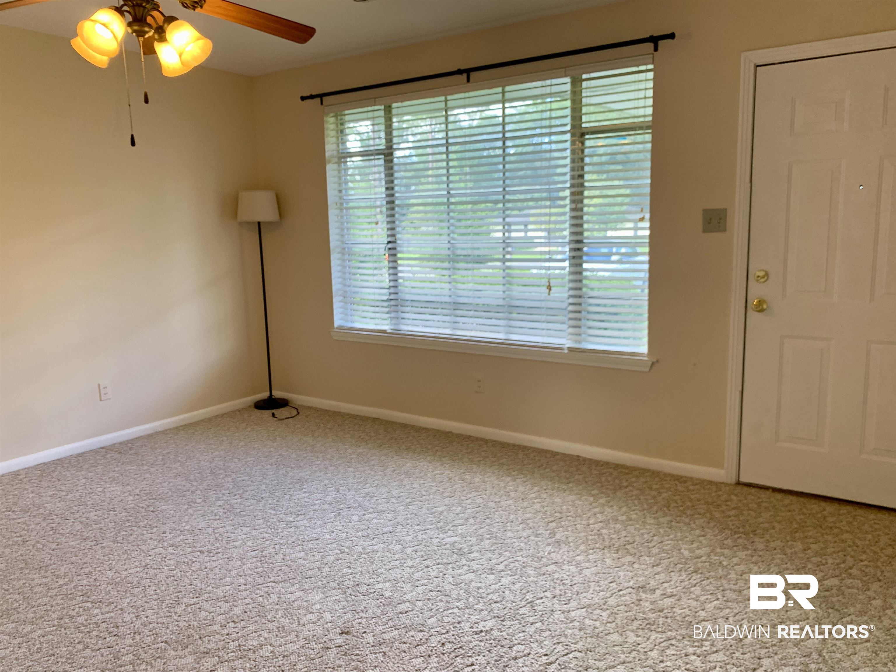 2710 West Road Mobile, AL 36693 - Photo 2 of 10 Carpeted spare room with ceiling fan and plenty of natural light